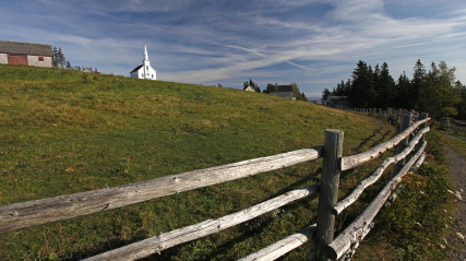 Field at Highland Village. Church in the background.