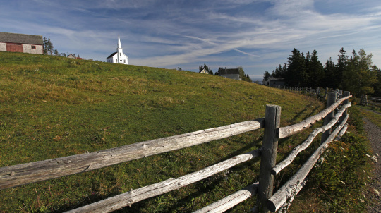 Field at Highland Village. Church in the background.